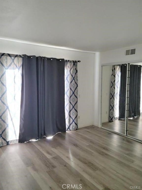 spare room featuring wood-type flooring