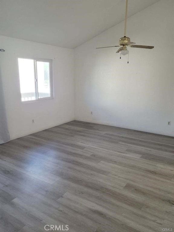 unfurnished room with vaulted ceiling, ceiling fan, and light hardwood / wood-style floors