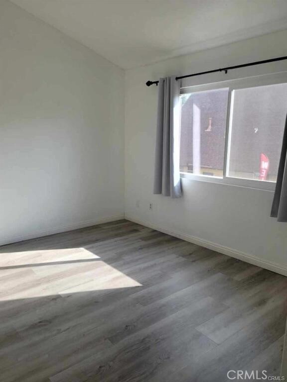 empty room featuring wood-type flooring