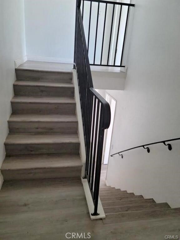 stairway with hardwood / wood-style flooring