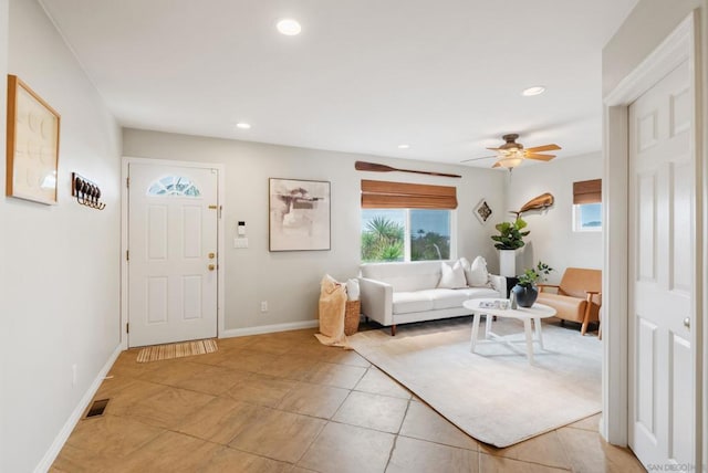 tiled living room featuring ceiling fan