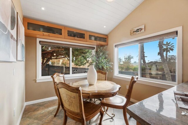 dining space featuring lofted ceiling