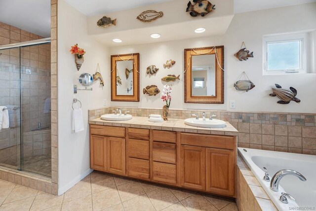 bathroom featuring vanity, plus walk in shower, and tile patterned flooring