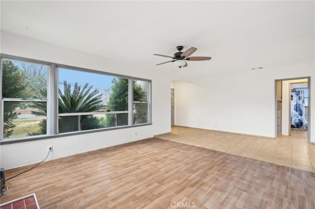 empty room featuring a ceiling fan and wood finished floors