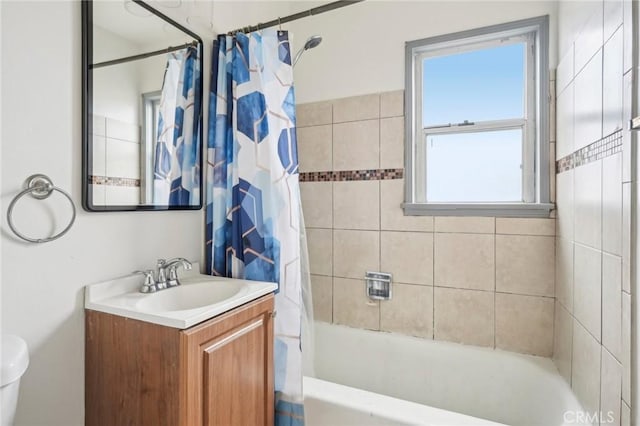 bathroom with toilet, shower / bath combo with shower curtain, and vanity