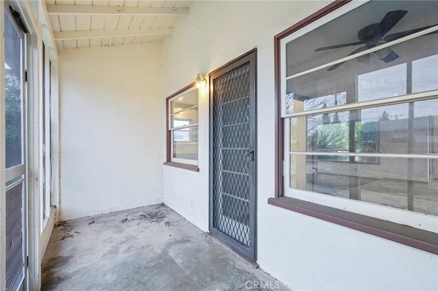 doorway to property featuring stucco siding