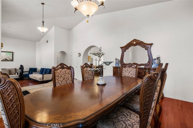 dining room with wood-type flooring and lofted ceiling