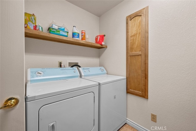 laundry room with cabinets and separate washer and dryer