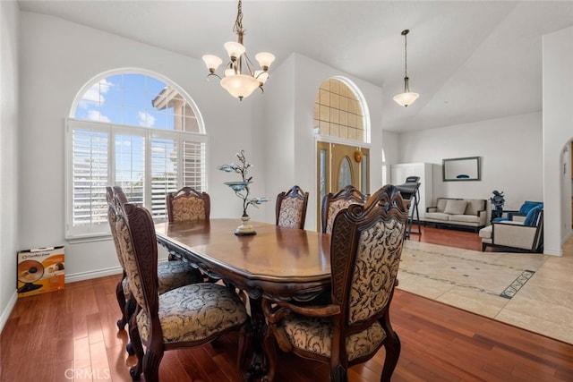 dining space featuring hardwood / wood-style flooring and a chandelier