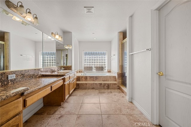 bathroom featuring vanity, separate shower and tub, tile patterned flooring, and a textured ceiling