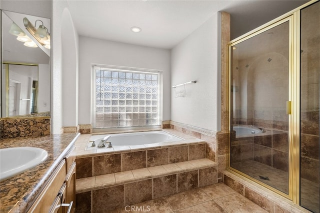 bathroom with vanity, tile patterned flooring, and plus walk in shower