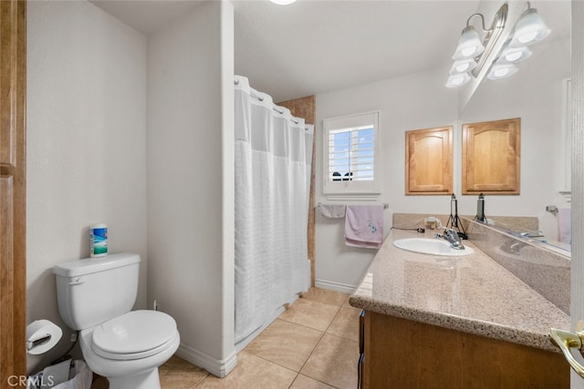 bathroom with tile patterned floors, vanity, toilet, and curtained shower