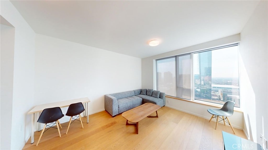 sitting room with wood-type flooring