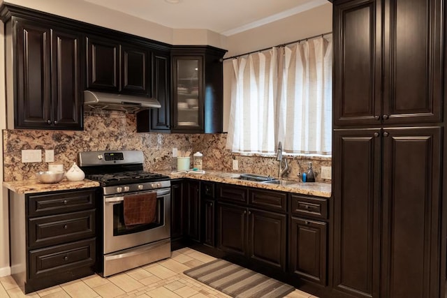 kitchen with stainless steel gas range, sink, tasteful backsplash, crown molding, and light stone countertops