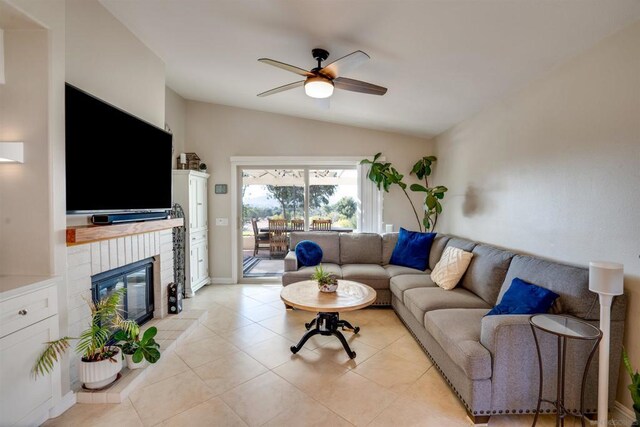 tiled living room featuring ceiling fan and lofted ceiling