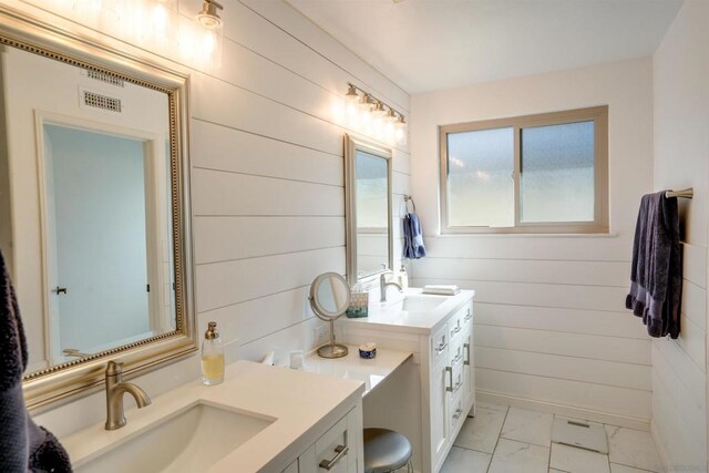 bathroom featuring vanity and wooden walls