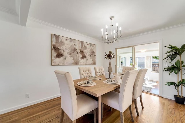 dining room featuring an inviting chandelier, crown molding, and wood-type flooring