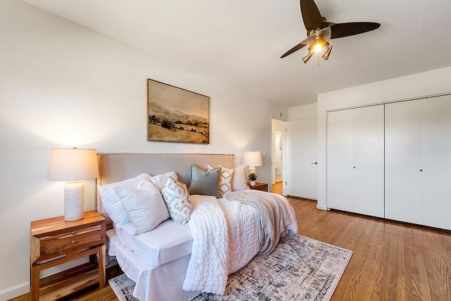 bedroom with wood-type flooring, a closet, and ceiling fan