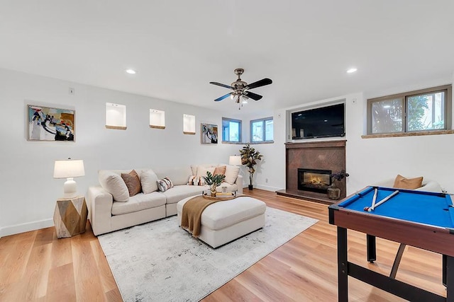 living room featuring ceiling fan, pool table, and hardwood / wood-style floors