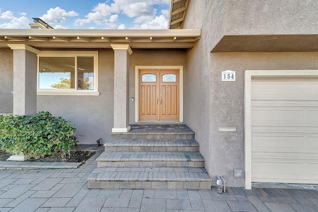 view of exterior entry with a garage