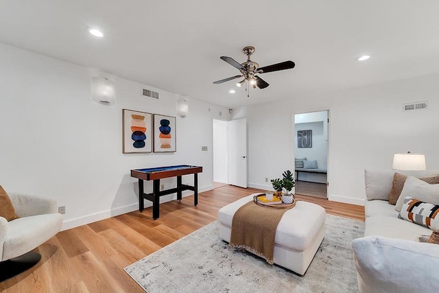 living room featuring hardwood / wood-style flooring and ceiling fan