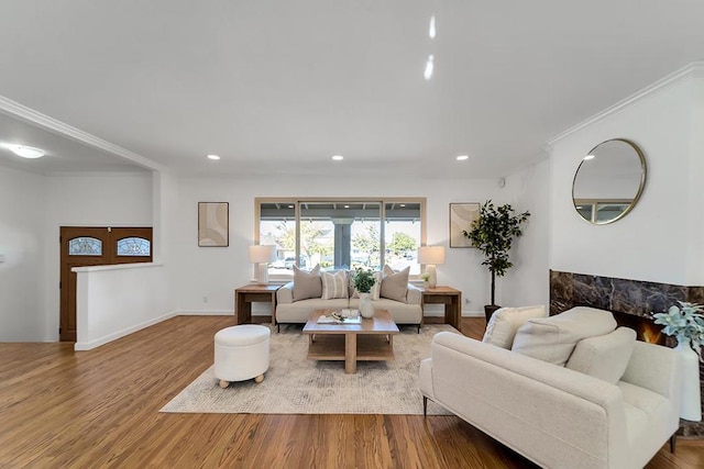 living room featuring wood-type flooring and ornamental molding