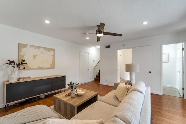 living room with hardwood / wood-style floors and ceiling fan