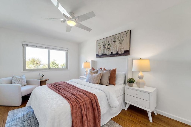 bedroom with ceiling fan and dark hardwood / wood-style flooring