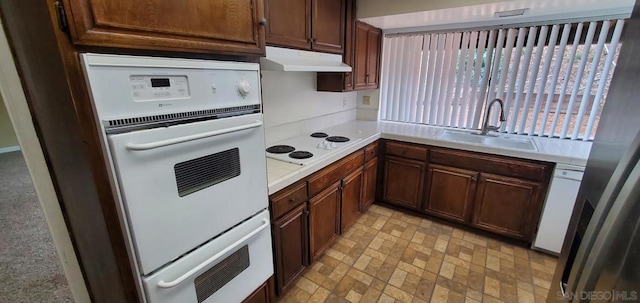 kitchen featuring sink and white appliances