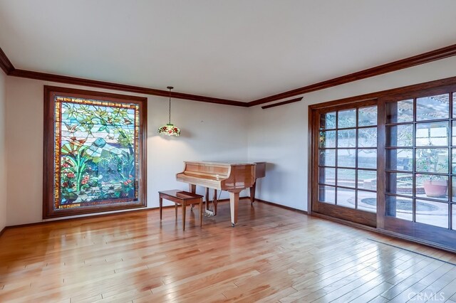 interior space with light hardwood / wood-style flooring and ornamental molding