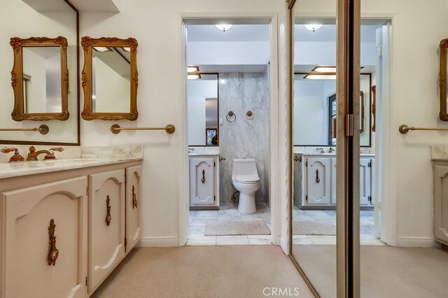 bathroom featuring vanity, tile patterned floors, and toilet