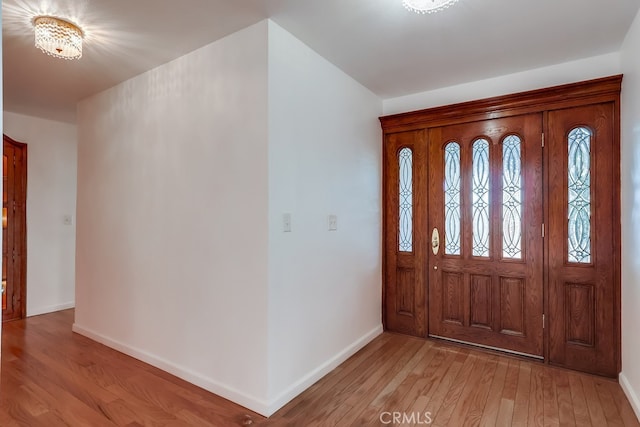 entrance foyer featuring an inviting chandelier and light hardwood / wood-style floors