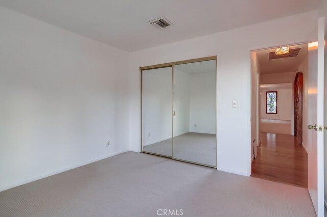 unfurnished bedroom with a closet and carpet