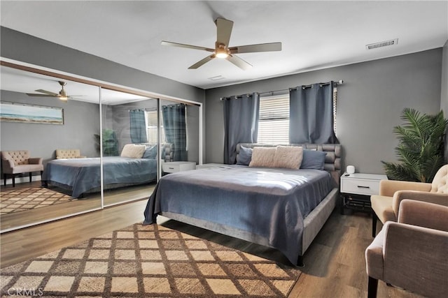 bedroom with dark wood-type flooring and ceiling fan