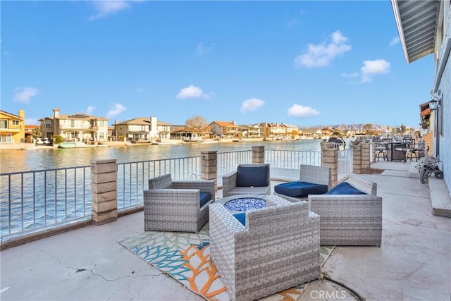 view of patio featuring a water view and a fire pit