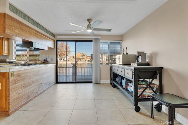 interior space with access to exterior and light tile patterned flooring