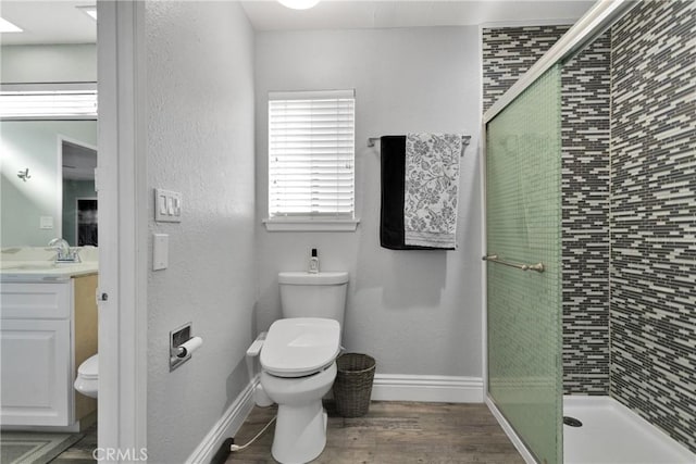 bathroom with walk in shower, wood-type flooring, and toilet