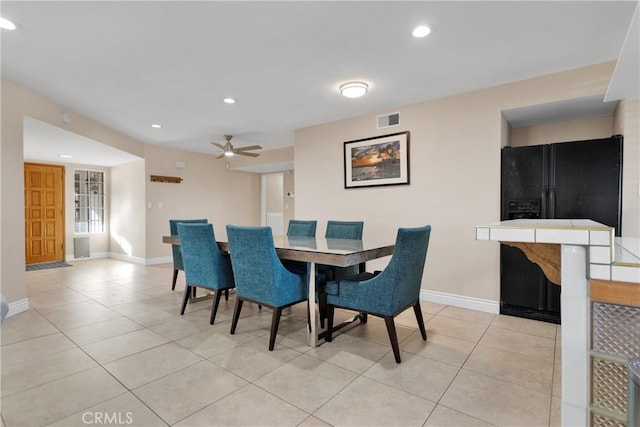 tiled dining area with ceiling fan