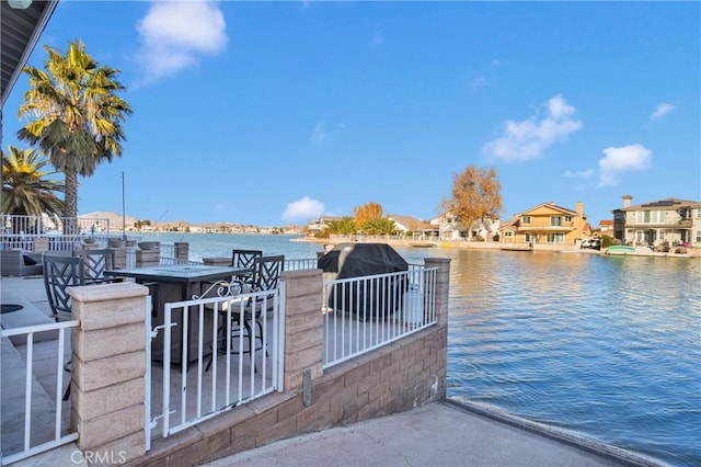 view of dock with a water view and exterior bar