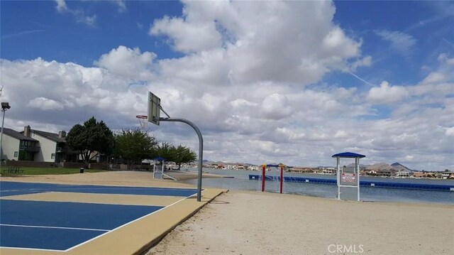 view of basketball court featuring a water view