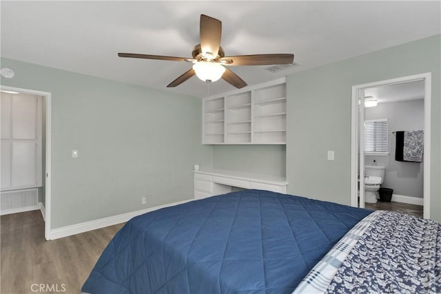 bedroom with hardwood / wood-style flooring, ensuite bathroom, and ceiling fan