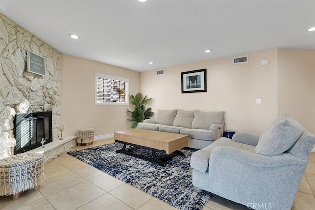 living room featuring light tile patterned flooring and a fireplace