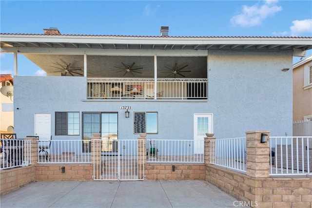 rear view of property featuring a patio area and ceiling fan