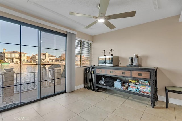 interior space featuring tile patterned flooring and ceiling fan