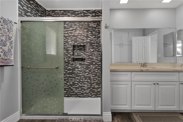 bathroom with vanity, hardwood / wood-style floors, and walk in shower