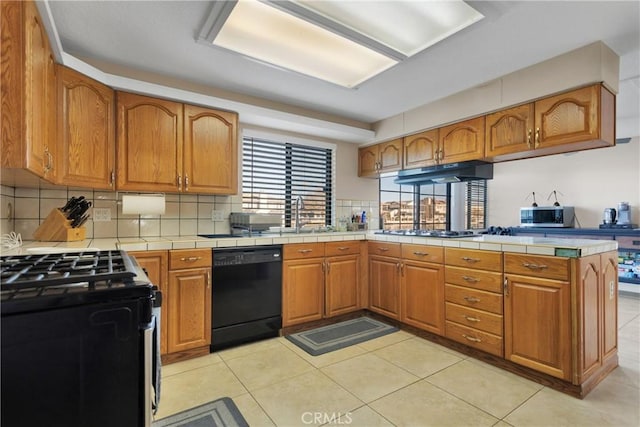 kitchen featuring tasteful backsplash, appliances with stainless steel finishes, and tile countertops