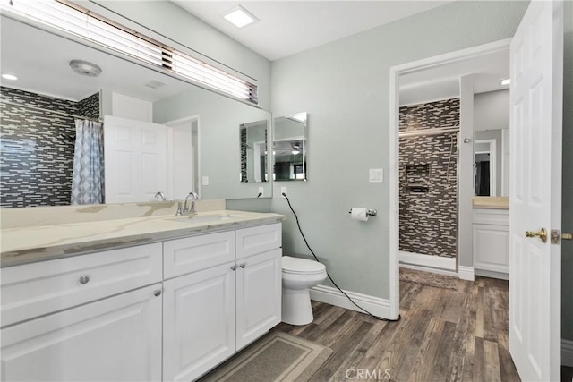 bathroom featuring vanity, hardwood / wood-style flooring, toilet, and a shower with shower curtain