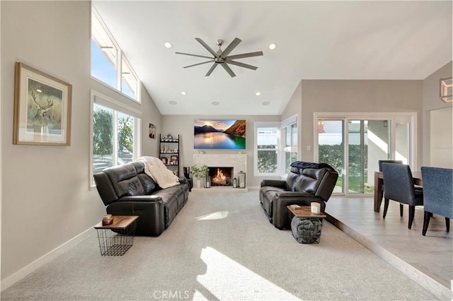 living room featuring light carpet, high vaulted ceiling, and a healthy amount of sunlight