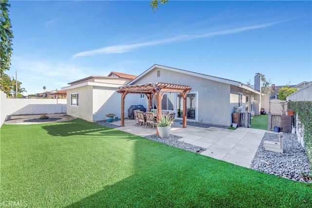 rear view of property featuring a yard, a pergola, and a patio