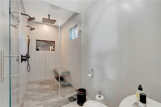 bathroom with walk in shower and toilet